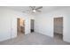 Spacious main bedroom features a ceiling fan, carpet floors, and adjacent bathroom and closet at 1132 Larkin Dr # 34, Buford, GA 30518