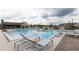 Community swimming pool with lounge chairs and cabana in a modern setting at 1132 Larkin Dr # 34, Buford, GA 30518