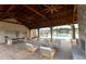 Outdoor entertaining space with a stone fireplace, a bar, lounge chairs and a view of the pool at 1132 Larkin Dr # 34, Buford, GA 30518