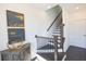 Elegant staircase with dark wood steps, black iron railings, and decorative artwork on the wall at 1132 Larkin Dr # 34, Buford, GA 30518