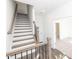 Bright foyer with stairs featuring wood treads, white risers, black iron balusters, and hardwood flooring at 1132 Larkin Dr # 34, Buford, GA 30518