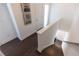 Hardwood staircase with white risers and modern railings lead to upper level at 1132 Larkin Dr # 34, Buford, GA 30518