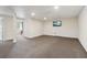 Bright, carpeted basement with a mounted TV and view to an adjacent room, ideal for a Gathering room at 3100 Meadow Dr, Marietta, GA 30062