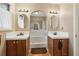 Bathroom with dual sinks, tile floor, and arched entryway to a soaking tub at 3100 Meadow Dr, Marietta, GA 30062