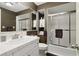 Compact bathroom featuring a shower-tub combo with sliding glass doors and classic white fixtures at 3100 Meadow Dr, Marietta, GA 30062