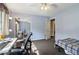 This bedroom features blue walls, a ceiling fan, and a closet with mirrored doors for added space at 3100 Meadow Dr, Marietta, GA 30062