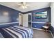 Comfortable bedroom features a large window, closet, mounted TV, and ceiling fan at 3100 Meadow Dr, Marietta, GA 30062