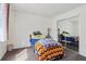 A bedroom with a closet with mirrored doors and a bed with a colorful blanket and pillows at 3100 Meadow Dr, Marietta, GA 30062