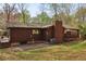 Rear exterior view of home, showing the deck, trees, lawn and house details at 3100 Meadow Dr, Marietta, GA 30062