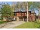 Two-story house with a stone base, wood siding, and a second-story balcony at 3100 Meadow Dr, Marietta, GA 30062