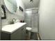 Stylish bathroom featuring a sink with modern faucet, and a shower with sliding glass doors and marbled tile walls at 6308 Boyett Drive Dr, Norcross, GA 30093