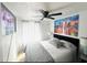 This is a view of a bedroom with a ceiling fan, a TV, city artwork and windows with curtains at 6308 Boyett Drive Dr, Norcross, GA 30093