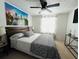Bedroom featuring a comfy bed with decorative pillows, cityscape artwork, and natural light from a window at 6308 Boyett Drive Dr, Norcross, GA 30093