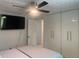 Cozy bedroom with ceiling fan, built-in storage, and a wall-mounted television at 6308 Boyett Drive Dr, Norcross, GA 30093
