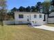 Exterior elevation of a two-story home with a front yard and driveway at 6308 Boyett Drive Dr, Norcross, GA 30093