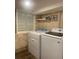Laundry room with stone-look walls, a window, a shelf, and a newer model washer and dryer at 6308 Boyett Drive Dr, Norcross, GA 30093