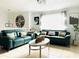 Stylish living room featuring modern sofas, decorative pillows, and a striking clock, perfect for comfortable and chic living at 6308 Boyett Drive Dr, Norcross, GA 30093