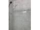 Close-up of a shower with white marbled tile, and shower head at 6308 Boyett Drive Dr, Norcross, GA 30093