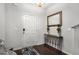 Welcoming entryway with dark wood floors, console table, mirror, and white front door at 1310 Roger Trace, Lithonia, GA 30058