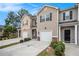 Charming townhouse row featuring attached garages, well-manicured landscaping and driveways at 1310 Roger Trace, Lithonia, GA 30058