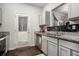 Modern kitchen featuring granite counters, stainless steel appliances and door to the backyard at 1310 Roger Trace, Lithonia, GA 30058