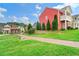 Exterior view of a green lawn with a brick sidewalk, trees, and community gazebo at 1780 Brookside Lay Cir, Norcross, GA 30093