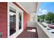 View from balcony with colorful siding overlooking community parking and neighboring buildings against blue skies at 1780 Brookside Lay Cir, Norcross, GA 30093