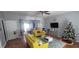 Bright living room featuring yellow couches and adjacent dining area with plenty of natural light at 1780 Brookside Lay Cir, Norcross, GA 30093