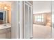 Bathroom sink and a large closet, leading to a carpeted living room and windows at 3403 Ashwood Ln, Atlanta, GA 30341