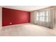 Spacious bedroom with neutral carpet, a large window with curtains, and a colorful accent wall at 3403 Ashwood Ln, Atlanta, GA 30341