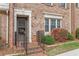 Brick townhome features a charming front porch, manicured bushes, and a well-kept lawn at 3403 Ashwood Ln, Atlanta, GA 30341