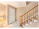 Bright entryway featuring a staircase with wood railing, tiled floors, and a white door at 3403 Ashwood Ln, Atlanta, GA 30341