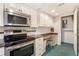 Well-lit kitchen features stainless steel appliances and a charming built-in desk area at 3403 Ashwood Ln, Atlanta, GA 30341