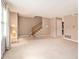 Open living room with carpeted floors, natural light, and a staircase at 3403 Ashwood Ln, Atlanta, GA 30341