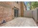 Private brick patio with sliding glass doors and views of the fenced backyard at 3403 Ashwood Ln, Atlanta, GA 30341