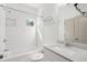 Well-lit bathroom with white subway tile surround, tub and shower combo, and modern vanity at 3706 Clovis Nw Ct, Atlanta, GA 30331