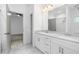 Bright bathroom featuring a double vanity, walk-in shower, and large mirror at 3706 Clovis Nw Ct, Atlanta, GA 30331