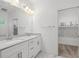 Elegant bathroom with double sink vanity, white cabinets, and walk-in closet for storage at 3706 Clovis Nw Ct, Atlanta, GA 30331