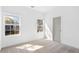 Bright bedroom featuring carpet, neutral wall color, two windows, and recessed lights at 3706 Clovis Nw Ct, Atlanta, GA 30331