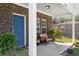 Close-up of a charming front porch with a bright blue door and cozy seating at 3706 Clovis Nw Ct, Atlanta, GA 30331
