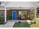 Charming brick home featuring a covered front porch with a bright blue door and cozy seating at 3706 Clovis Nw Ct, Atlanta, GA 30331