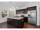 Modern kitchen with stainless steel appliances, dark cabinets and granite countertops at 3706 Clovis Nw Ct, Atlanta, GA 30331