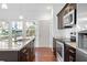 Bright modern kitchen with granite countertops, stainless appliances, and dark cabinets at 3706 Clovis Nw Ct, Atlanta, GA 30331