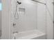 Stylish bathroom featuring a tub and shower with white subway tile and modern fixtures at 3706 Clovis Nw Ct, Atlanta, GA 30331