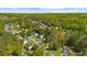 A high aerial view shows a neighborhood filled with houses surrounded by lush green trees at 1725 Silverchase Sw Dr, Marietta, GA 30008