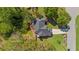 An aerial view of the house showcasing the roof, backyard, and surrounding greenery at 1725 Silverchase Sw Dr, Marietta, GA 30008