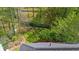 Aerial view of backyard showing the fence, treeline, and garden at 1725 Silverchase Sw Dr, Marietta, GA 30008