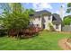 Beautiful backyard featuring a well-maintained lawn, wooden deck, mature trees, and fenced perimeter at 1725 Silverchase Sw Dr, Marietta, GA 30008
