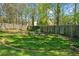 Serene backyard with a well-kept lawn, decorative garden, and an inviting outdoor seating area at 1725 Silverchase Sw Dr, Marietta, GA 30008