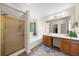 Bright bathroom with a large vanity, walk-in shower, soaking tub, and a large mirror above the vanity at 1725 Silverchase Sw Dr, Marietta, GA 30008